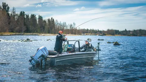 Deux messieurs pêchant sur un bateau équipé de deux moteurs Honda BF60 en milieu aquatique.