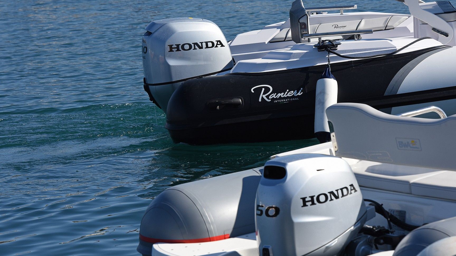 Gros plan de la Honda BF50 à l'arrière du bateau en bord de mer.